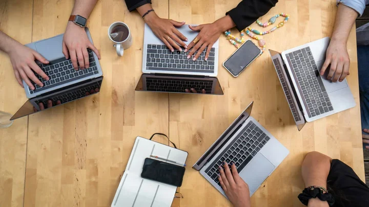 People working on laptops at a table