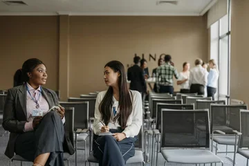 Two people talking in a classroom