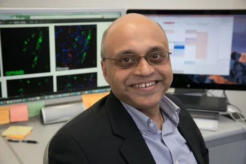 Photo of Dr. Arjun Deb sitting at his desk