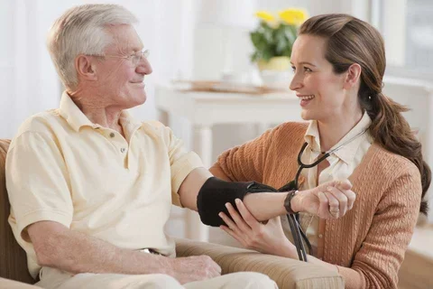 Nurse taking man's blood pressure