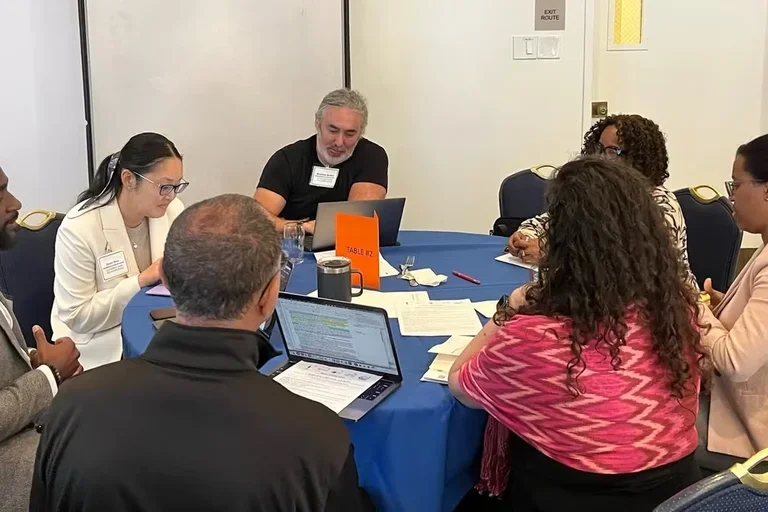 Participants around table at writing seminar