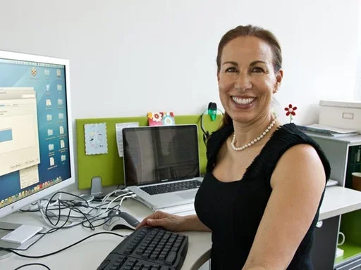Marlene Berro sits in front of a computer monitor