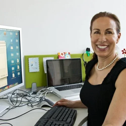 Marlene Berro sits in front of a computer monitor