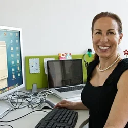 Marlene Berro sits in front of a computer monitor