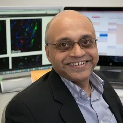 Photo of Dr. Arjun Deb sitting at his desk