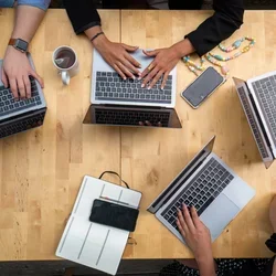 People working on laptops at a table
