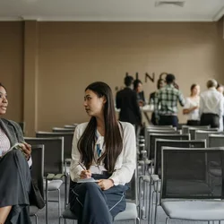 Two people talking in a classroom