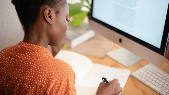 Woman Writing in Notebook