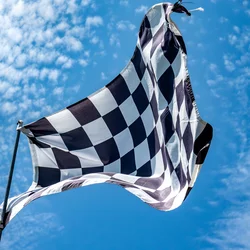 Checkered fag against a blue sky